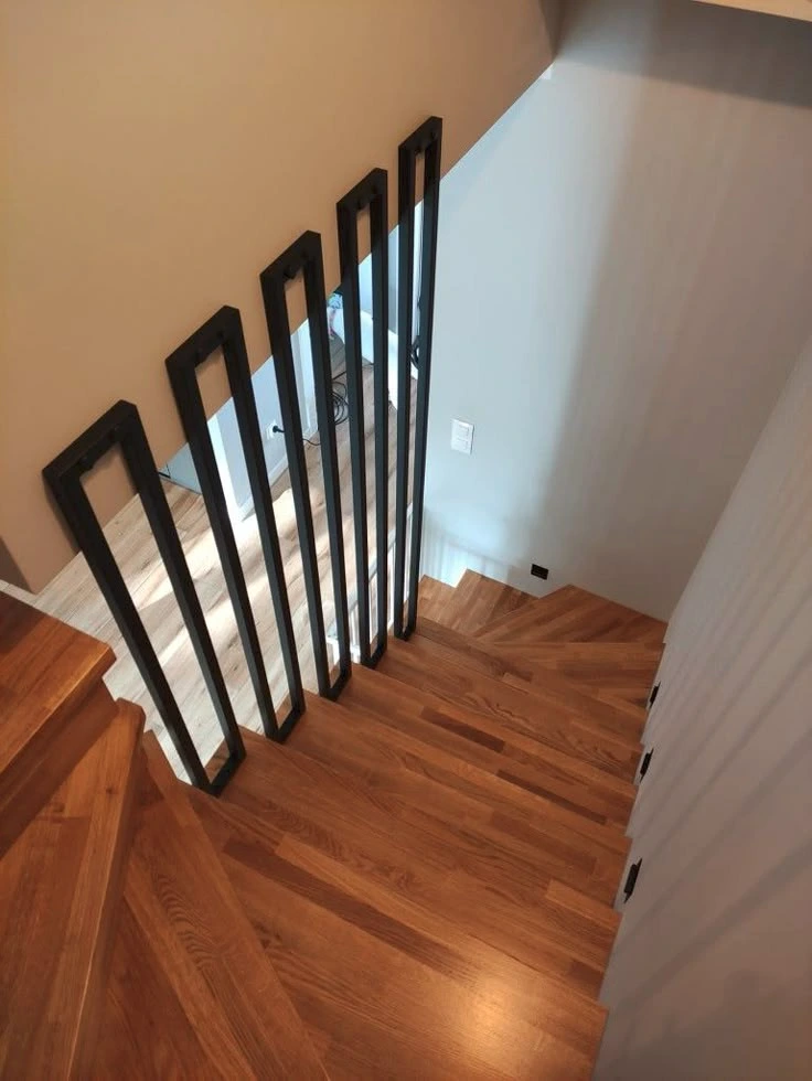 Floating wooden staircase with metal railing